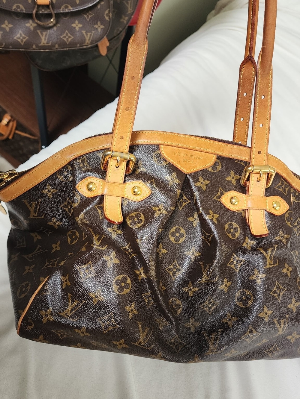 Louis Vuitton Monogram Tivoli GM bag featuring pleated coated canvas